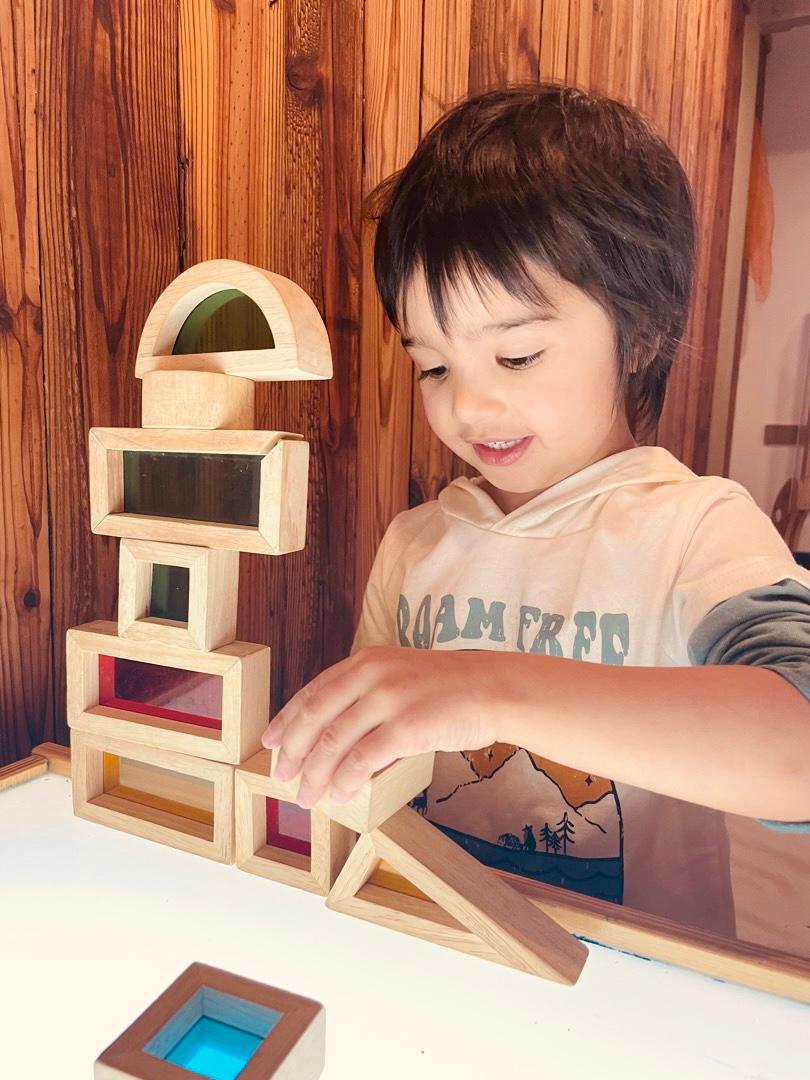 Child playing with stacking blocks activity