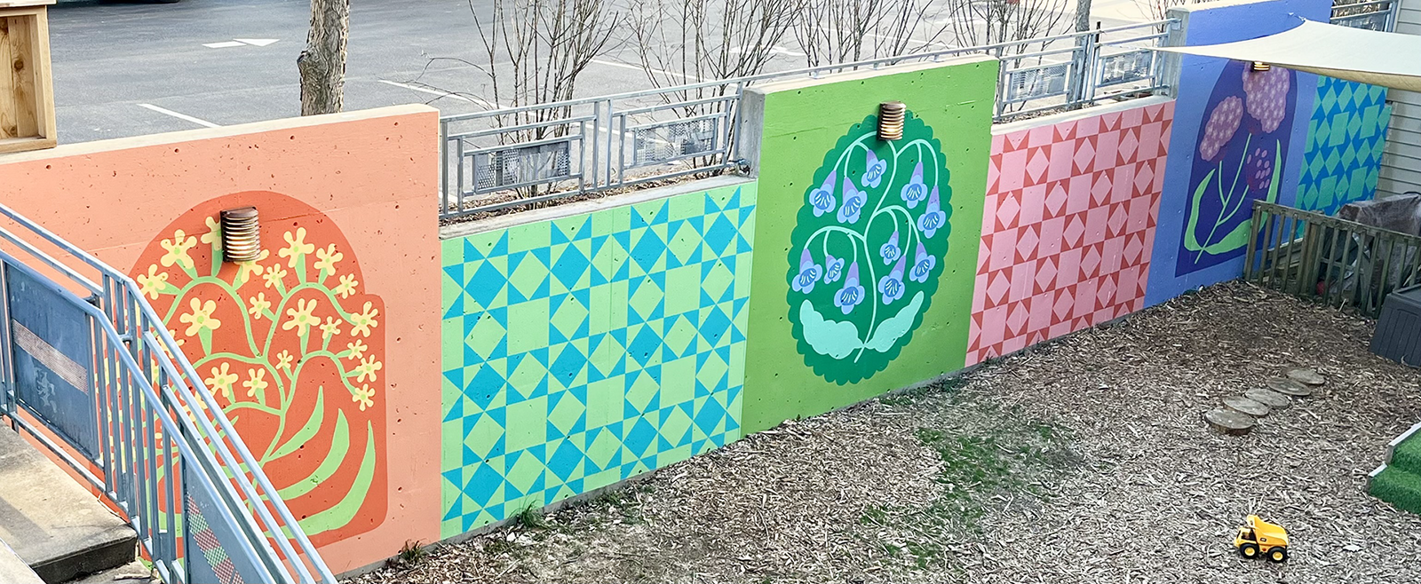 Colorful hand-painted mural along the Lexington Friends Preschool playground