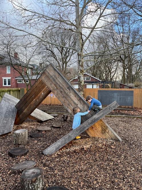 Children climbing on artistic wooden structure