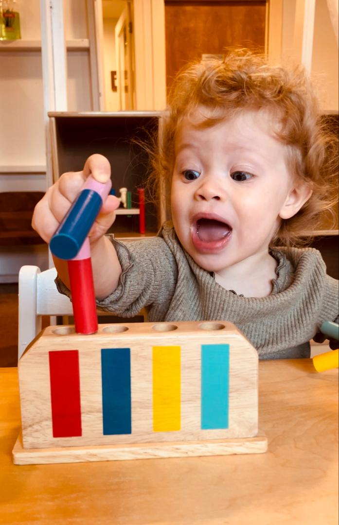 Child playing with shapes and colors matching game