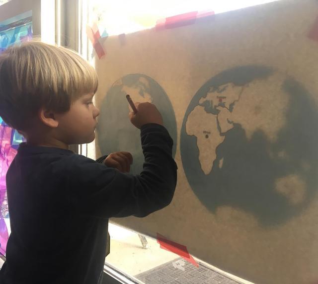 Child tracing continents
