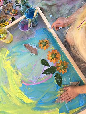 Child doing colorful fingerpaint crafts